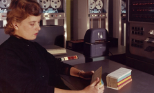 A woman working with an old punch-card computer